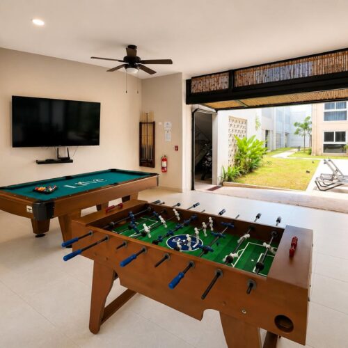 Game room with foosball and pool table at KAIA Jacó