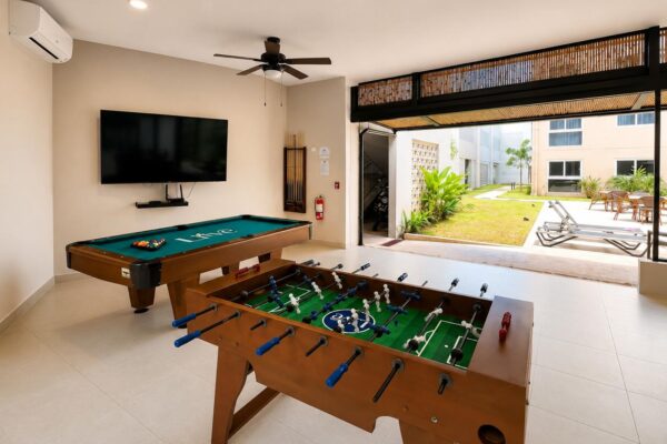 Game room with foosball and pool table at KAIA Jacó